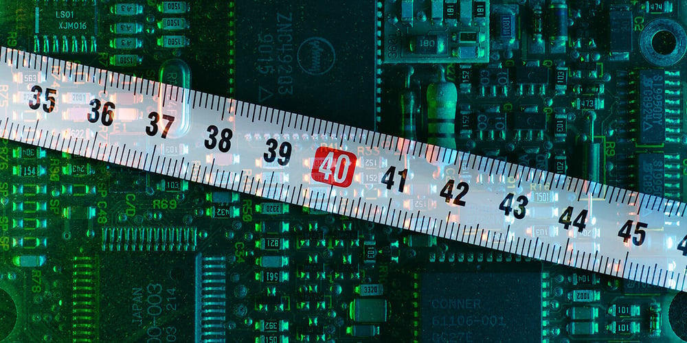 A ruler against a PCB to measure coating