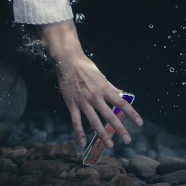 hand reaching underwater for a phone